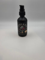 A matte black grooming spray bottle with a black pump dispenser, featuring a circular label that reads 'STONE & SILK GROOMING CO' with an illustration of a grooming brush and hand, set against a plain light gray background.