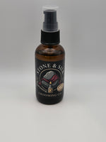 An amber glass spray bottle with pre shave oil