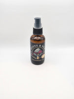 An amber glass spray bottle with pre shave oil